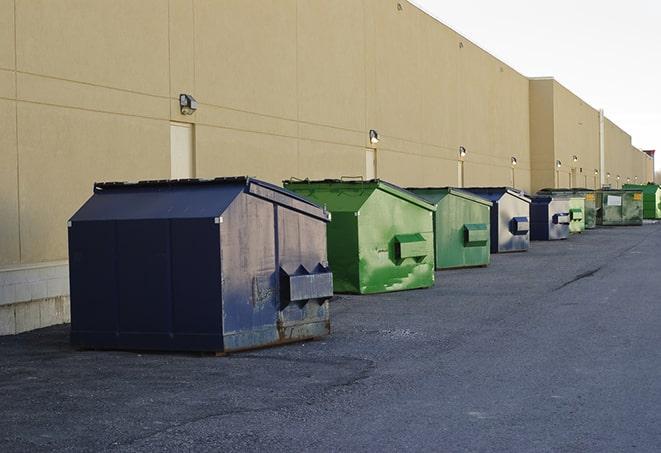 waste collection receptacles placed near a worksite in Bolton